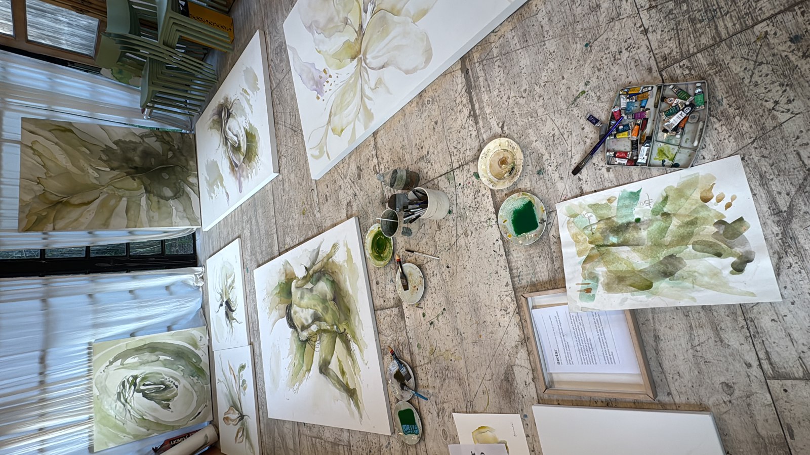 Overhead view of a painting in progress on the studio floor